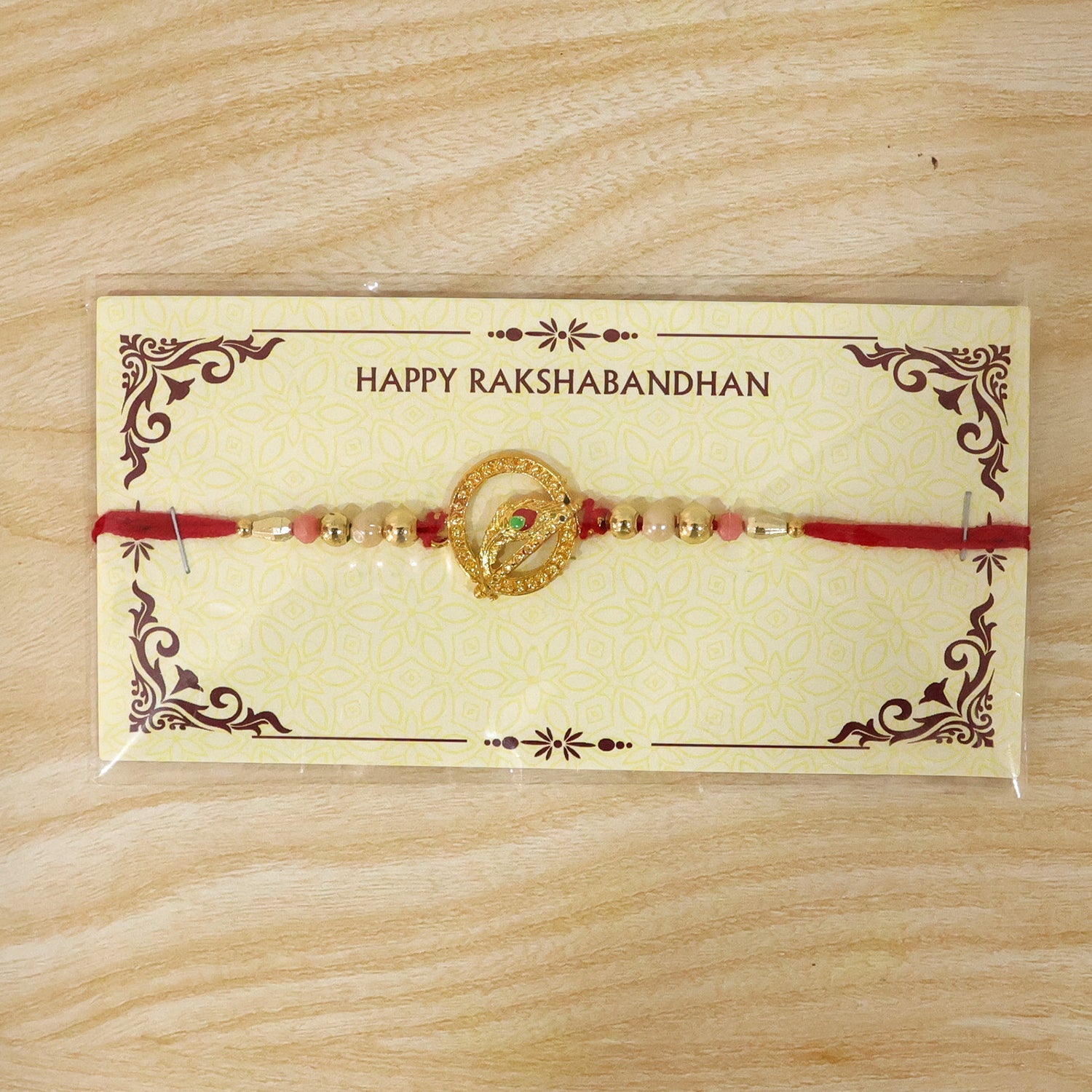 Golden Peacock Spiral Rakhi with Beads