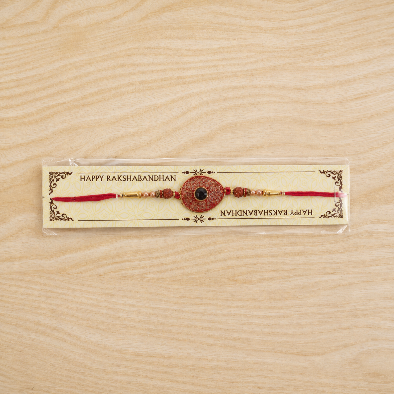 Red Meenakari Oval Disc Rakhi with Rudraksha & Pearls