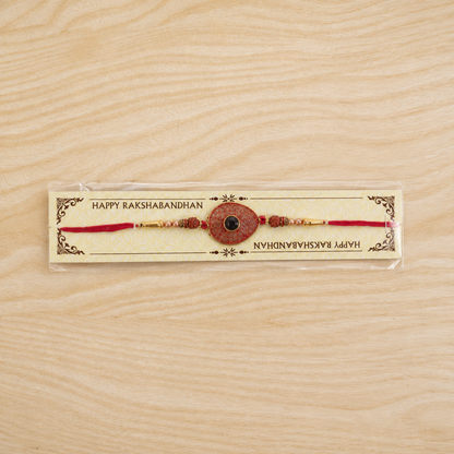 Red Meenakari Oval Disc Rakhi with Rudraksha & Pearls