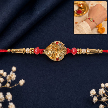 Golden Ganesha Oval Rakhi with Red Crystal Beads