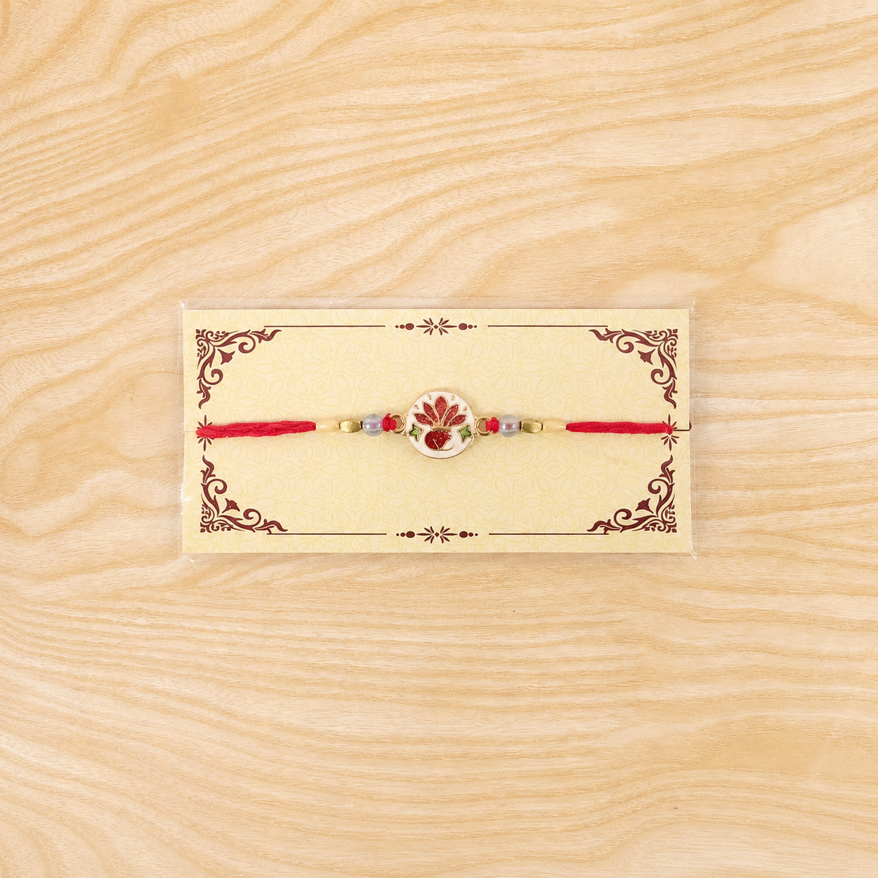 Hand-Painted Ceramic Floral Rakhi with Red Beads