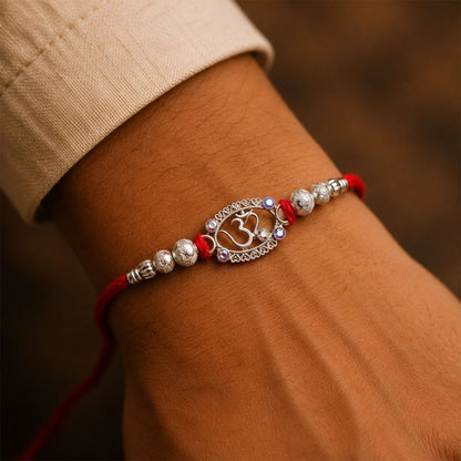 Oxidised Silver Om (?) Rakhi with Crystal Beads