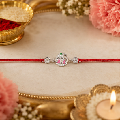 Silver Floral Meenakari Rakhi on Red Thread