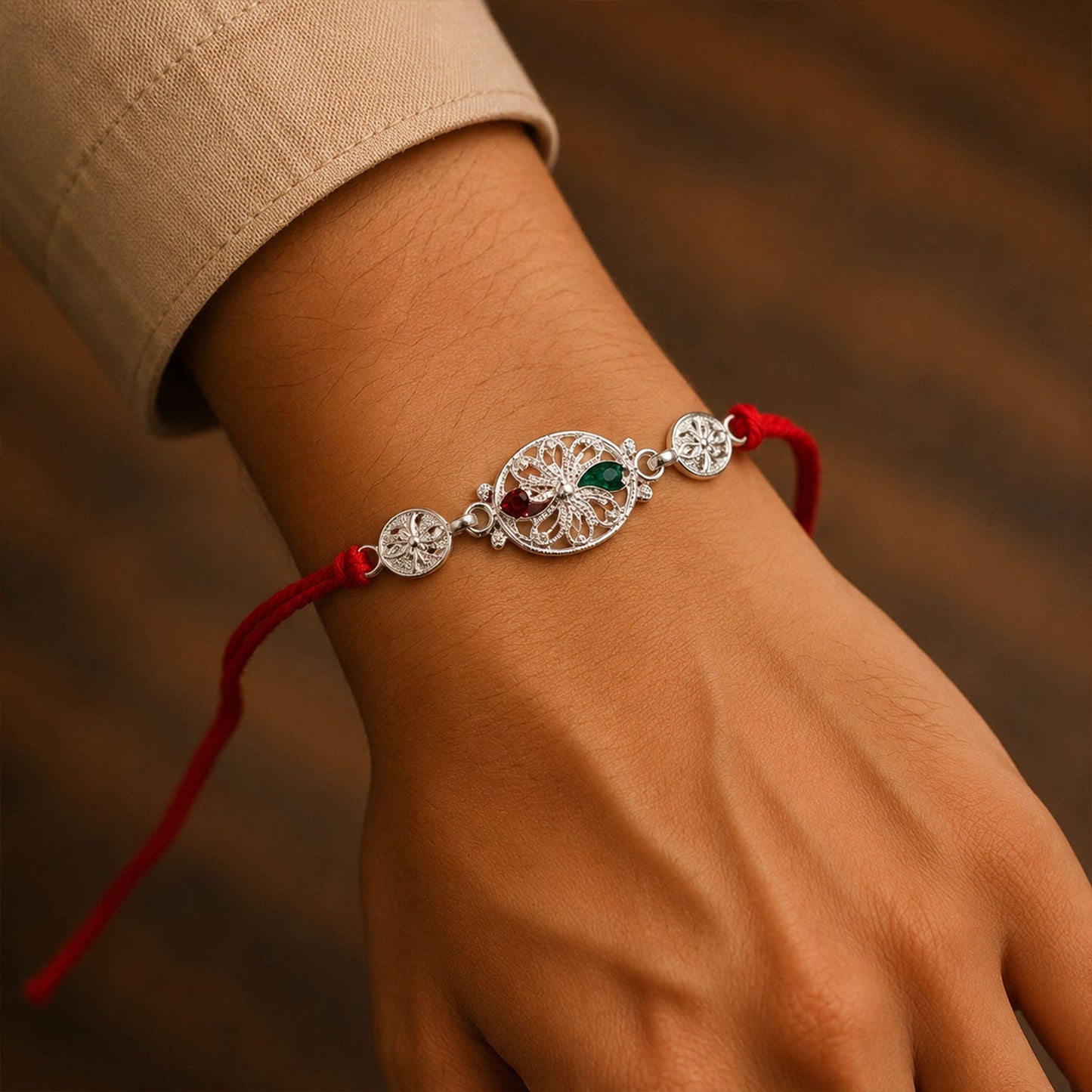 Silver Filigree Rakhi with Red & Green Teardrop Stones