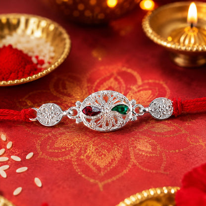 Silver Filigree Rakhi with Red & Green Teardrop Stones