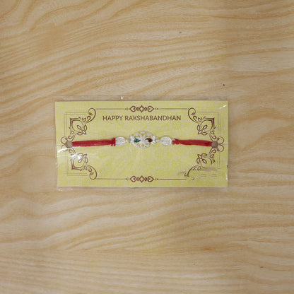 Silver Filigree Rakhi with Red & Green Teardrop Stones