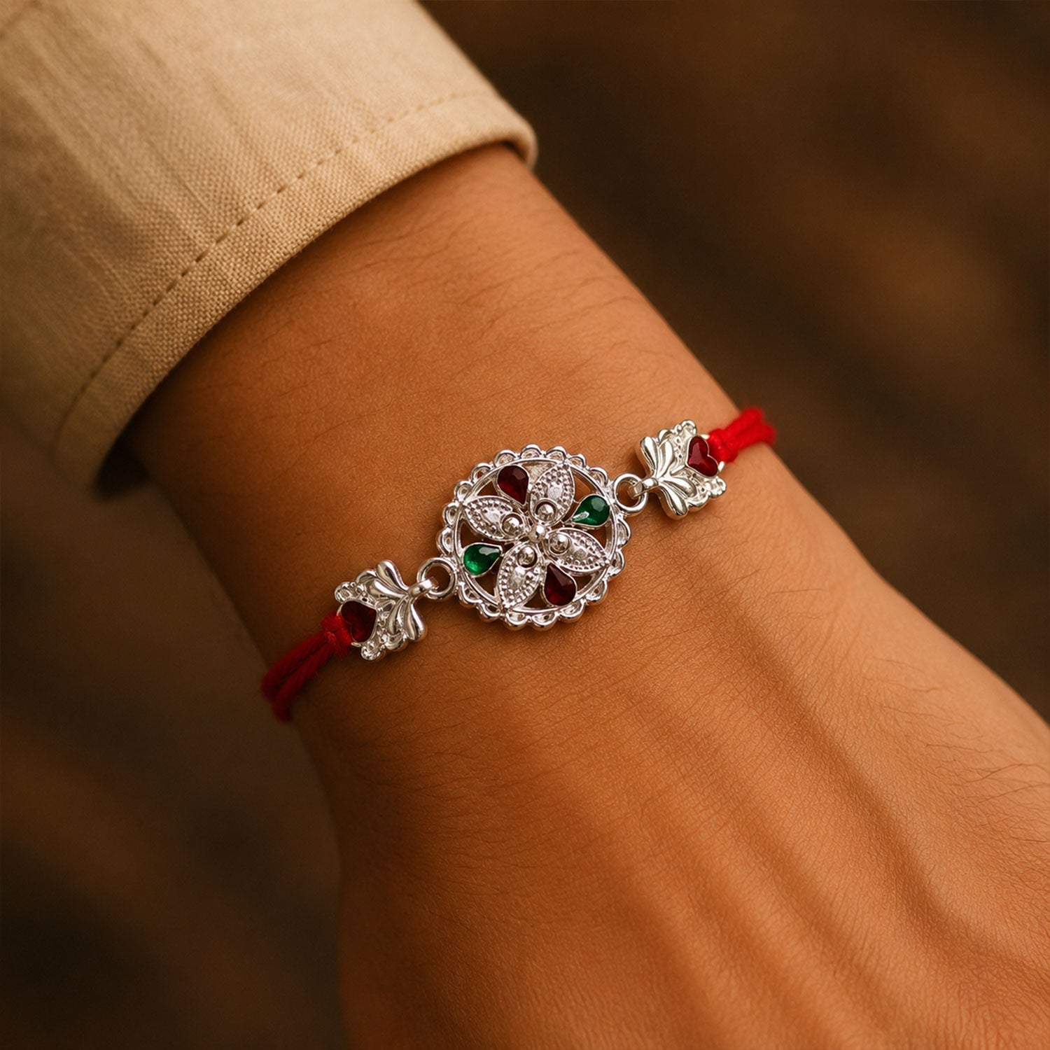 Silver Floral Rakhi with Red & Green Teardrop Stones
