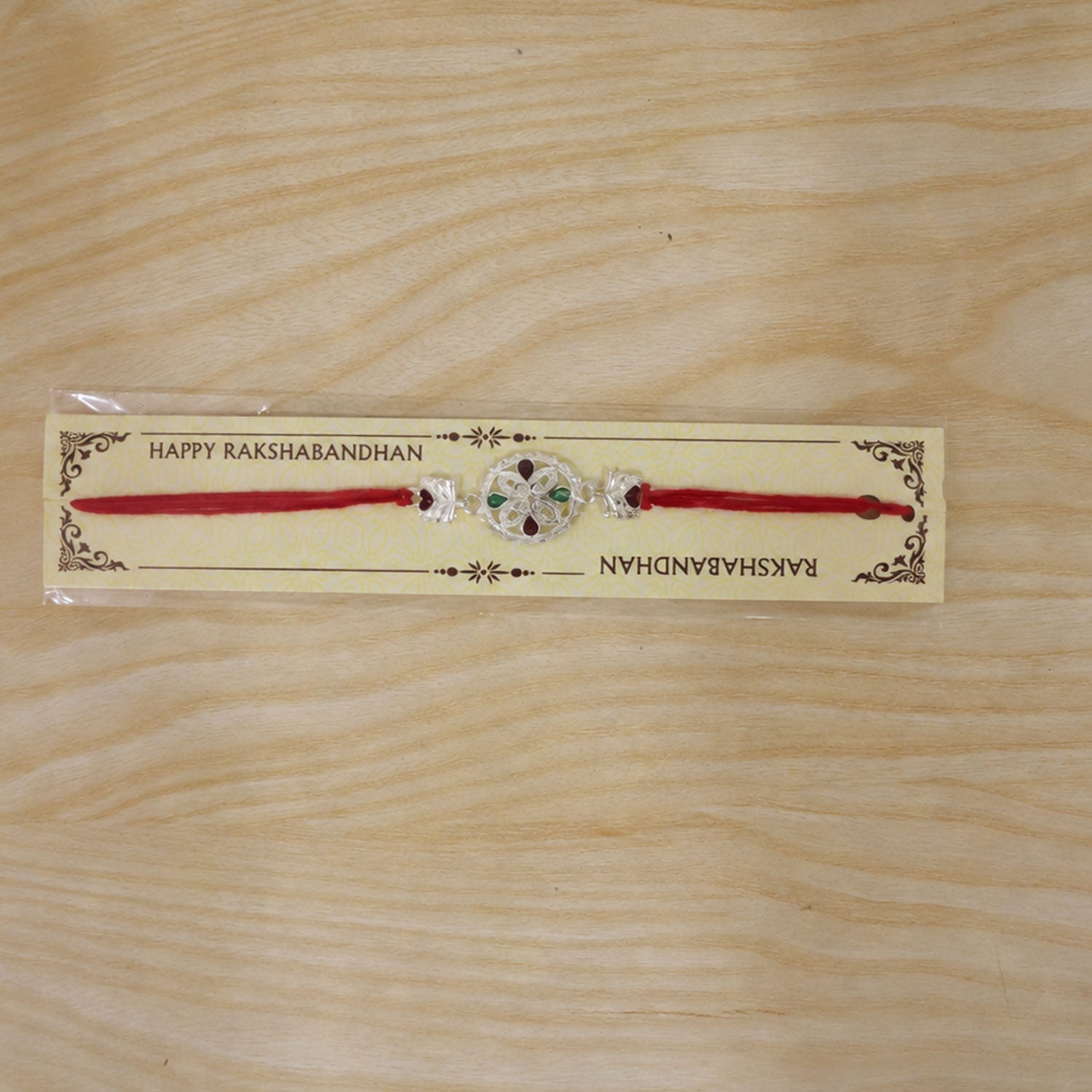 Silver Floral Rakhi with Red & Green Teardrop Stones