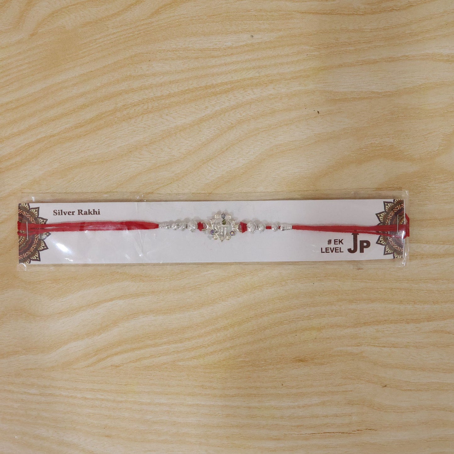 Silver Swastik Rakhi with Red Stones & Beads