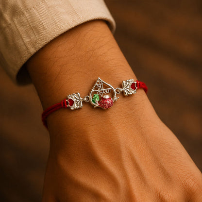 Silver Peacock Meenakari Rakhi with Red & Green Accents