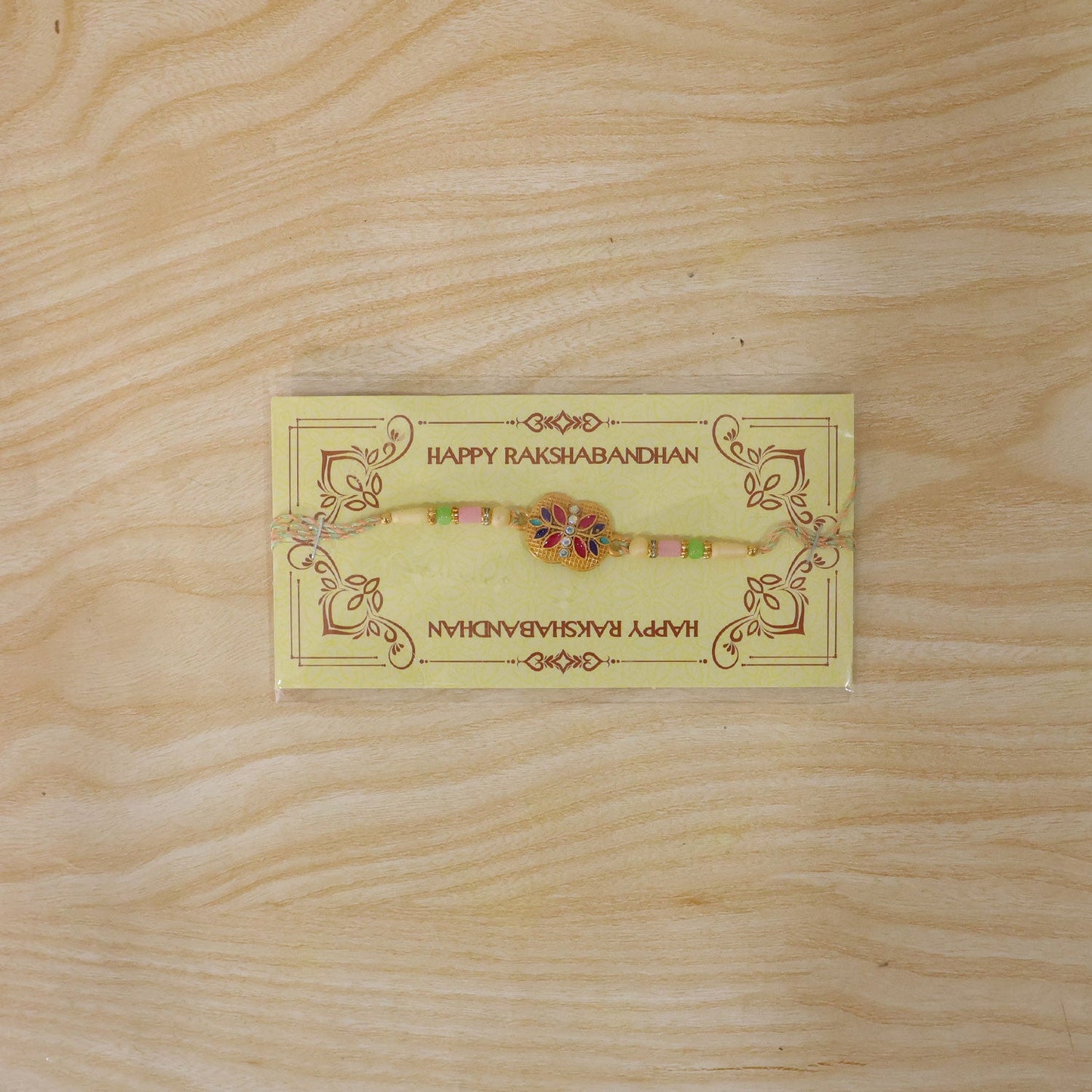 Golden Meenakari Floral Rakhi with AD Stones & Pearls for Brother