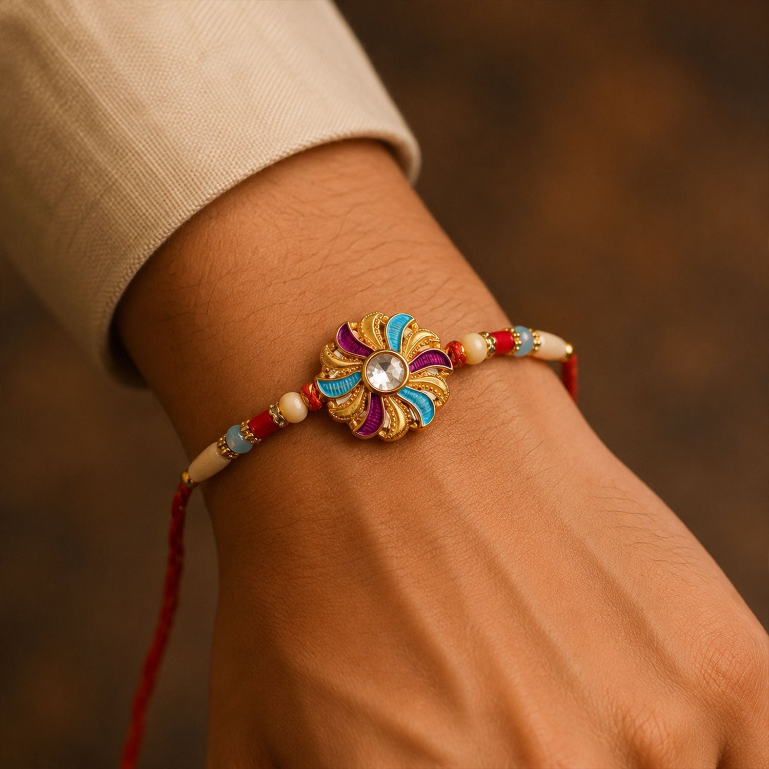 Golden Meenakari Pinwheel Rakhi with Enamel & Diamond Stone