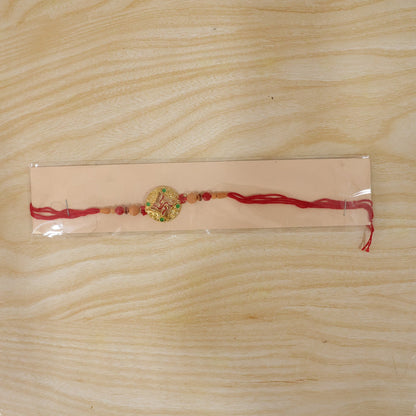 Auspicious Golden Swastik Rakhi with Wooden & Red Beads for Brother
