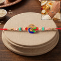 Golden Meenakari Peacock Rakhi – Elegant Traditional Design for Brothers
