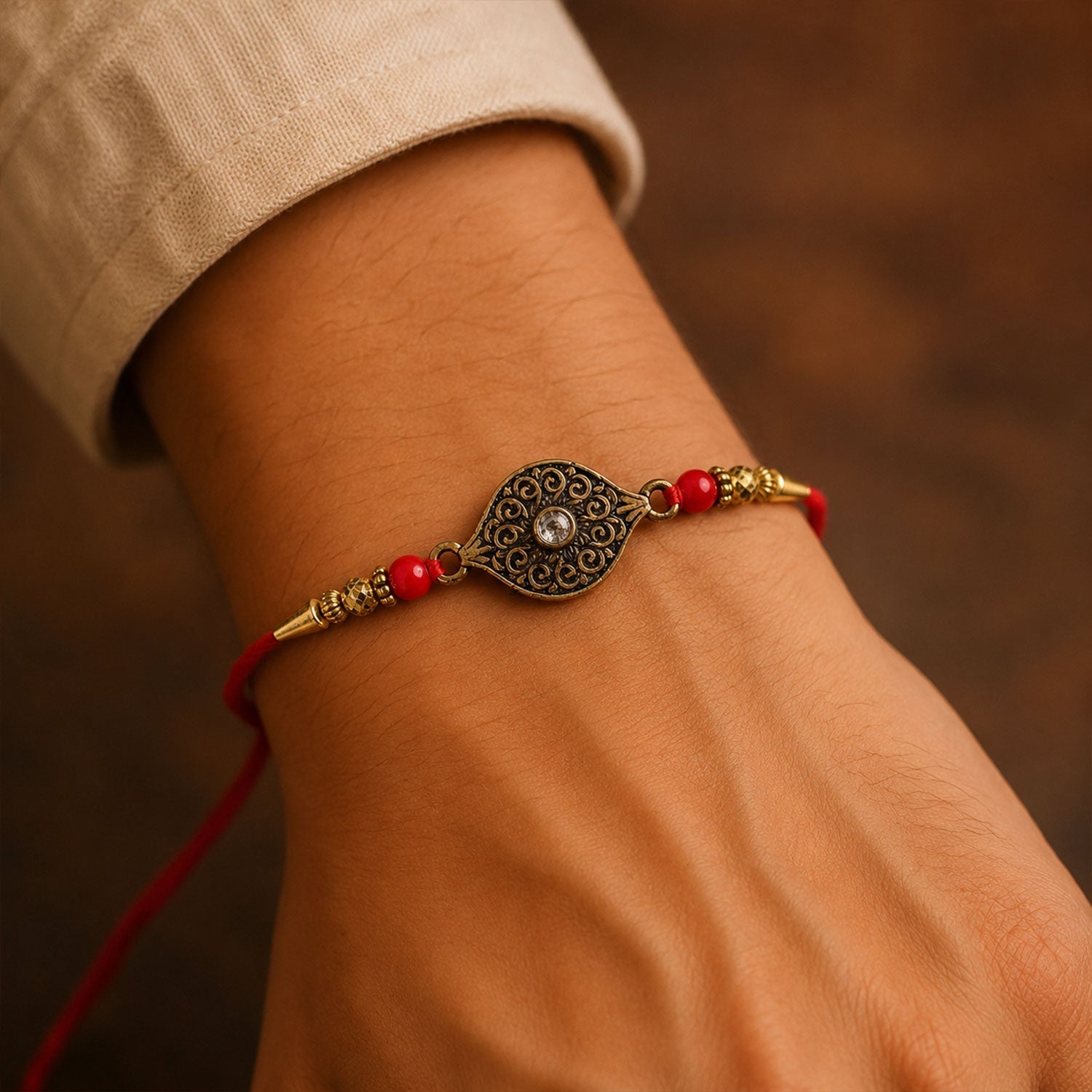 Antique Oval Rakhi with Red Crystal Beads for Brother