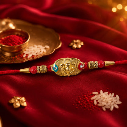 Golden Lord Ganesha Oval Rakhi with Red & Blue Beads for Brother