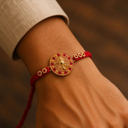Elegant Golden Ganesha Round Rakhi with Red Crystal Bead for Brother
