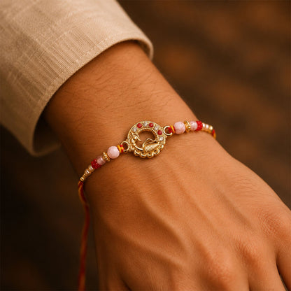Antique Golden Peacock Round Rakhi with Pearl & Red Beads for Brother