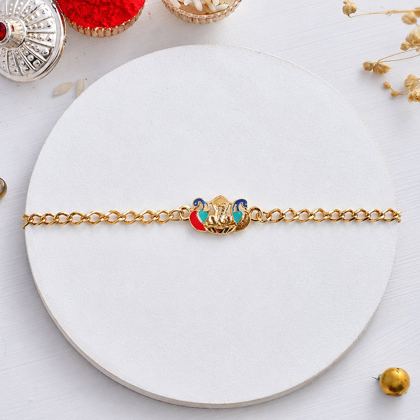 Side view of decorative beaded Peacock Ganesh rakhi bracelet