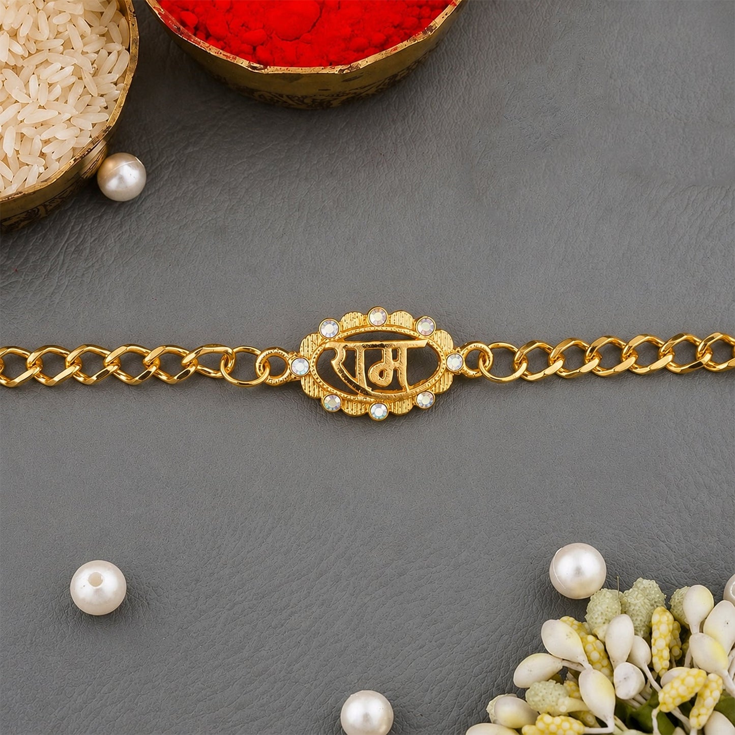 Close up of Ram Text Pearl Stone Gold Tone Rakhi Bracelet centerpiece