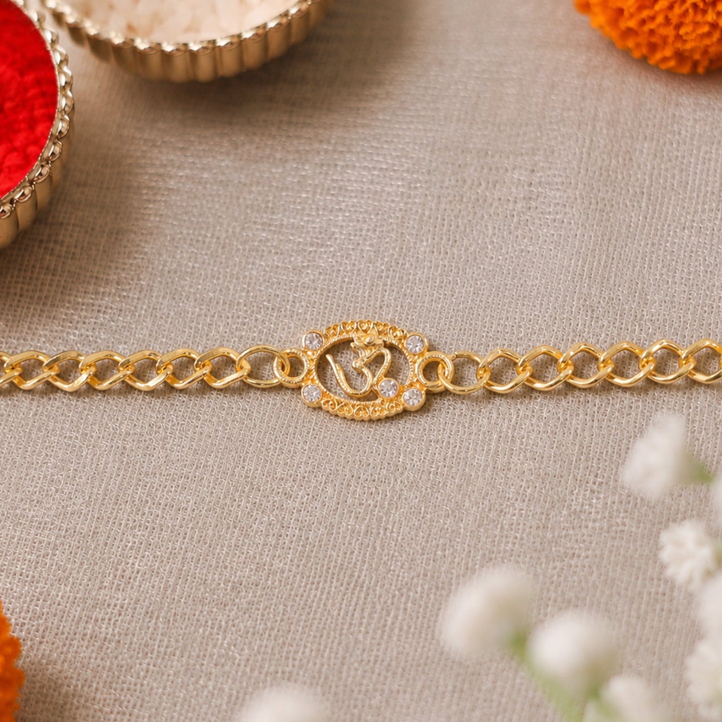 Om Stone Studded Gold Tone Rakhi Bracelet for Raksha Bandhan