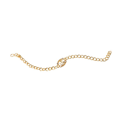 Styled view of Om stone gold tone rakhi bracelet