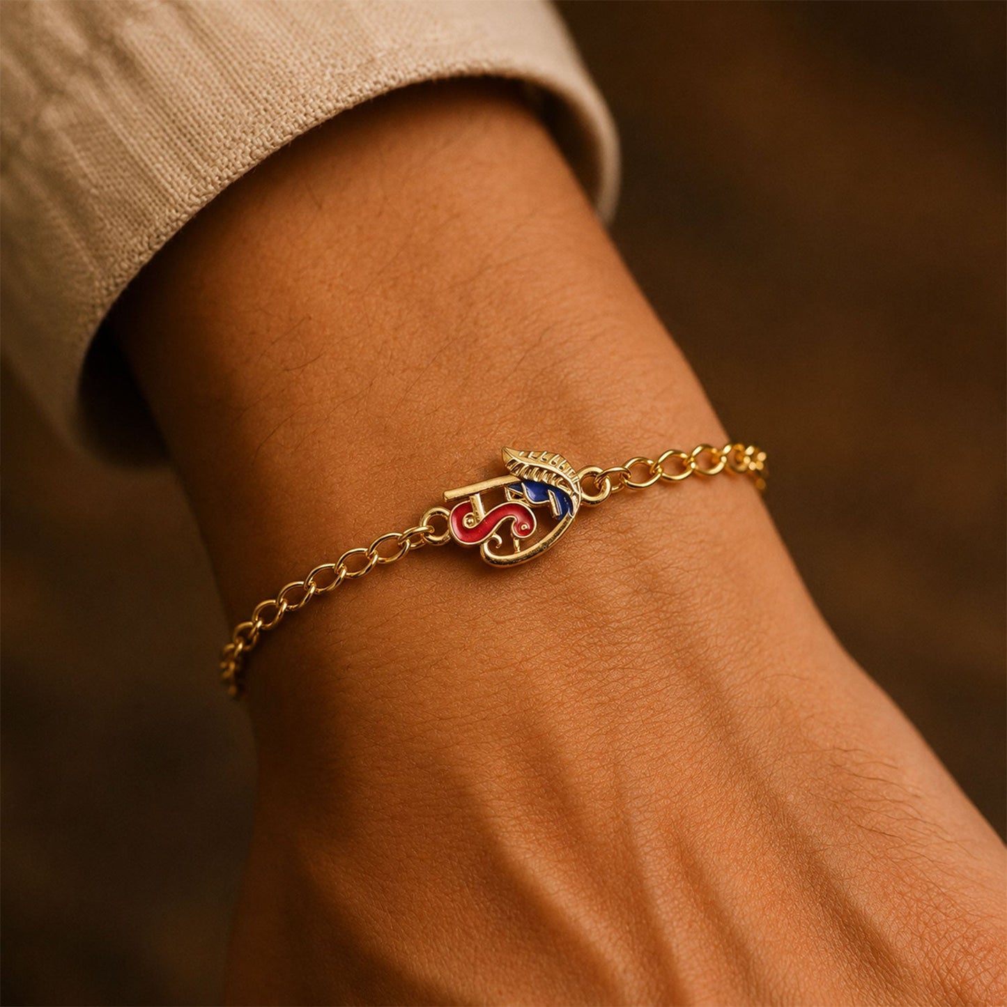 Decorative beads on Red Blue Enamel Gold Tone Rakhi