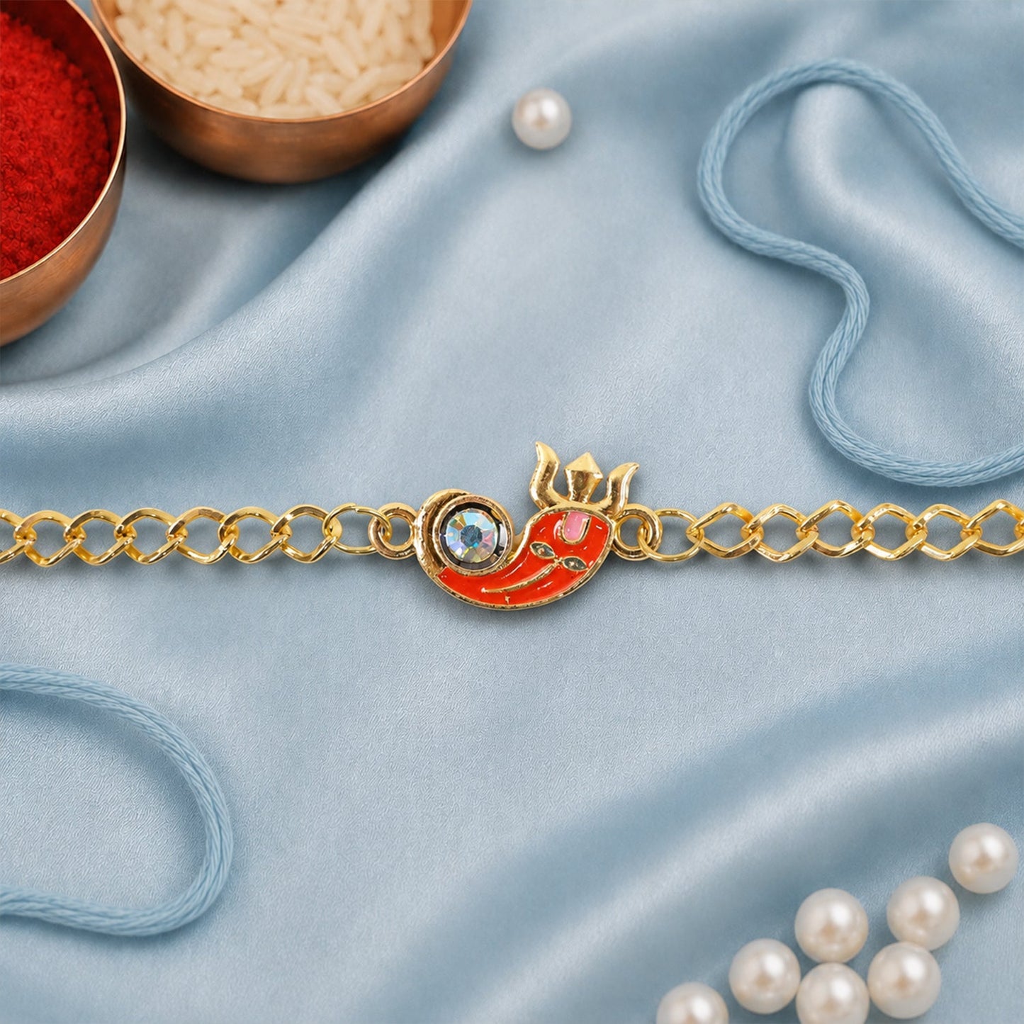 Ganesha rakhi bracelet laid flat showing decorative elements