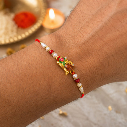 Krishna Matki Rakhi with Peacock Feather and Pearl Beads