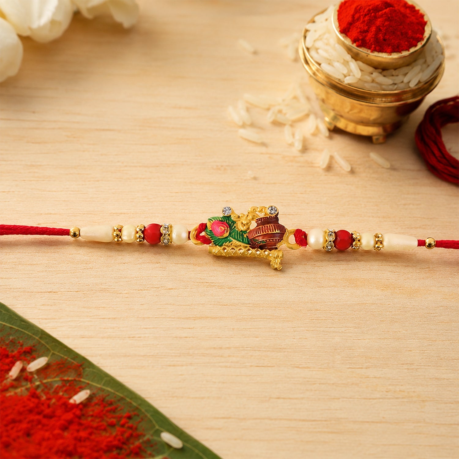 Krishna Matki Rakhi with Peacock Feather and Pearl Beads