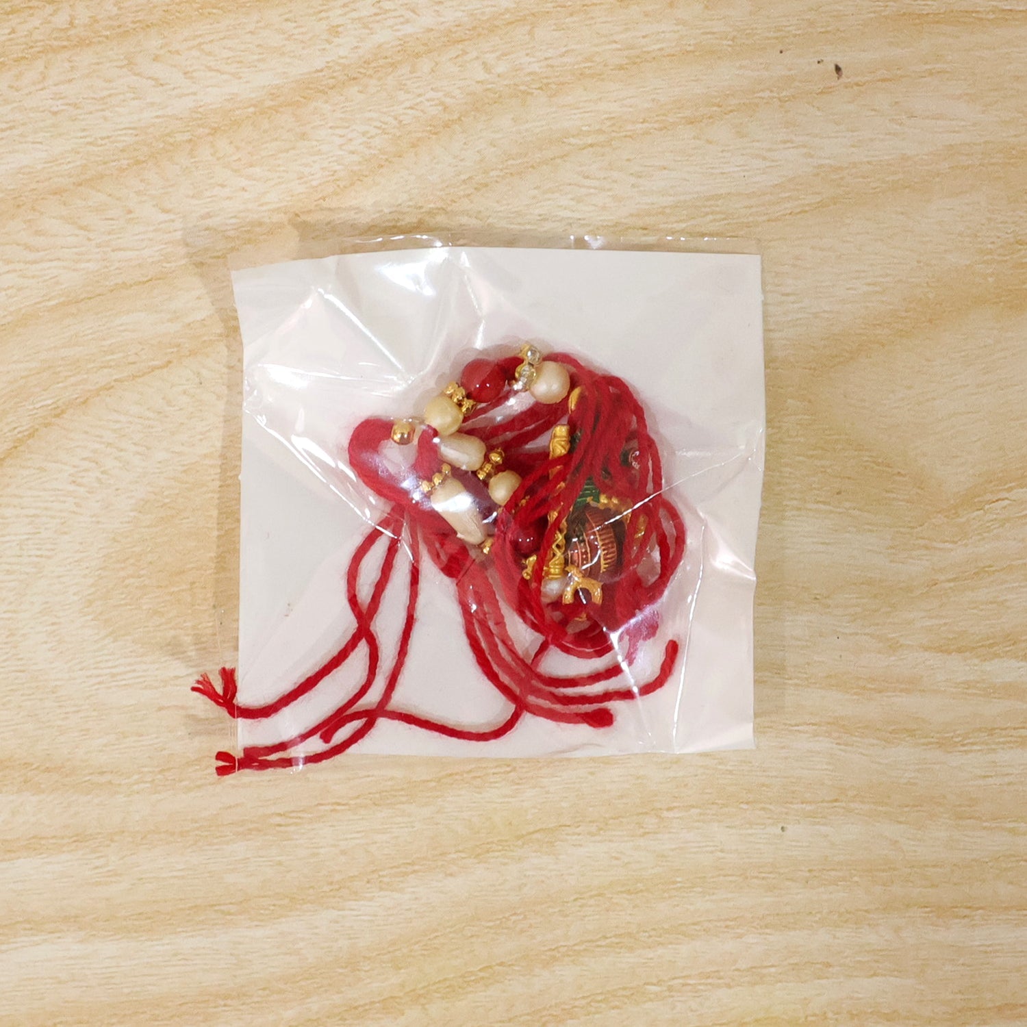 Krishna Matki Rakhi with Peacock Feather and Pearl Beads