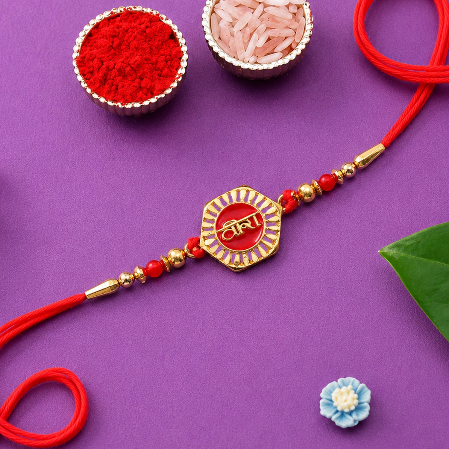Close-up of Veera Red Enamel Rakhi design & gold tone accents