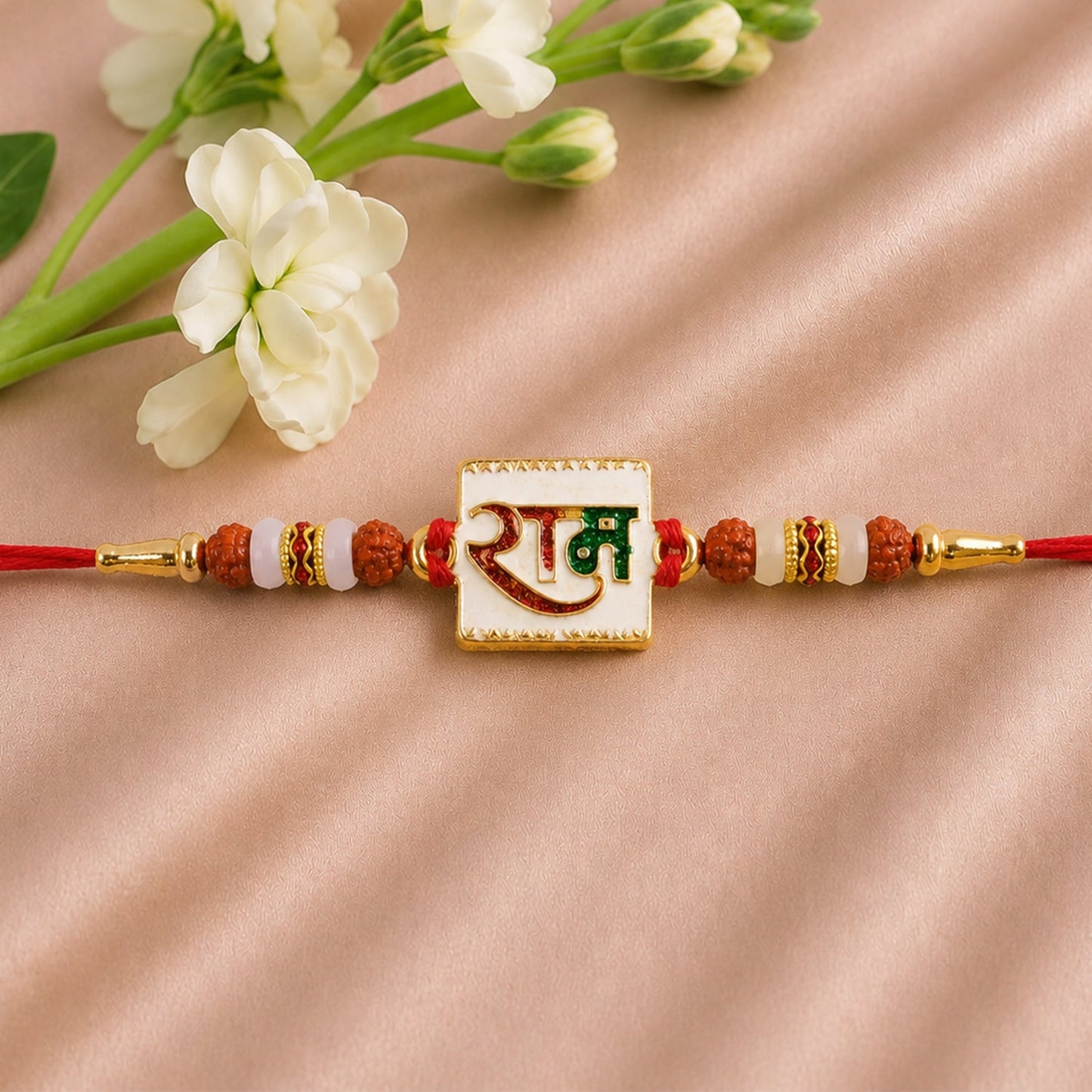 Angled view of Ram Text White Enamel Gold Tone Rakhi
