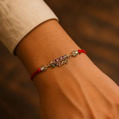 Kanha Black Enamel Gold Tone Rakhi on white background