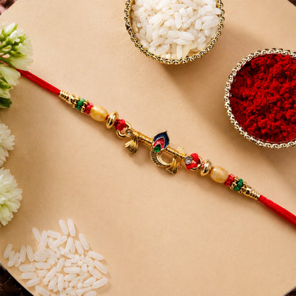 Close-up of the gold tone peacock feather & multicolor beads on Rakhi