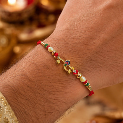 Side view of the Peacock Feather Rakhi with intricate beadwork