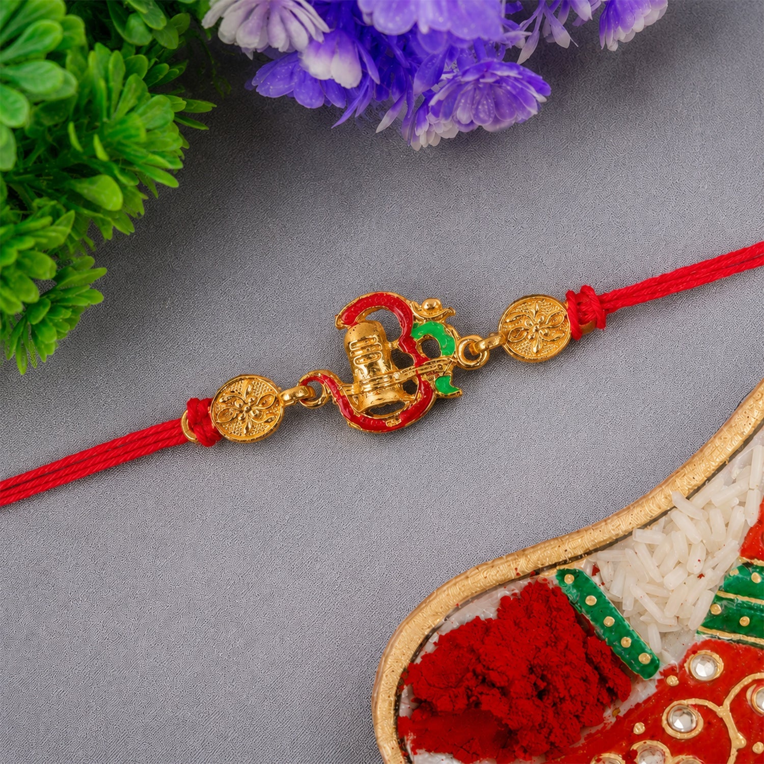 Gold tone Shivling Rakhi with intricate detailing