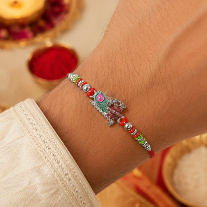 Close-up of Krishna Matki Rakhi with vibrant beads & feather