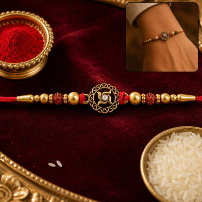 Golden Swastik Rakhi with Red Crystal Beads