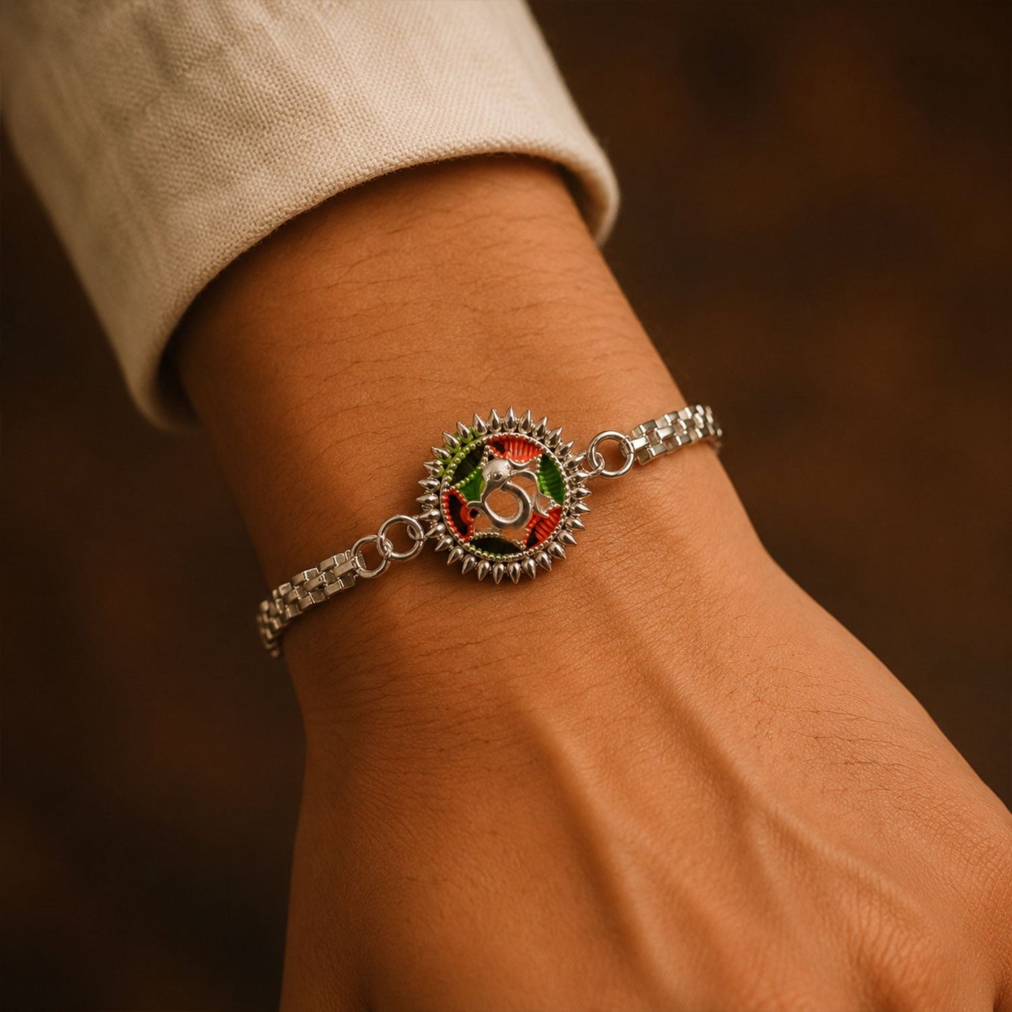 Silver Oxidized Meenakari Om Rakhi with Sunray Design