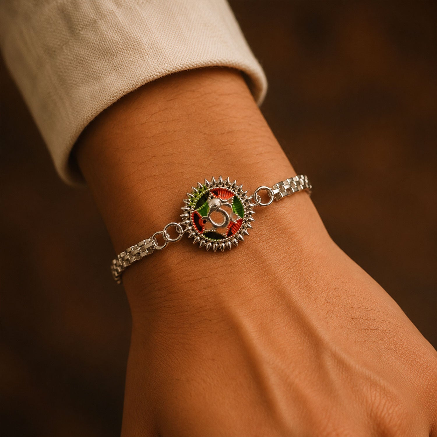 Silver Oxidized Meenakari Om Rakhi with Sunray Design
