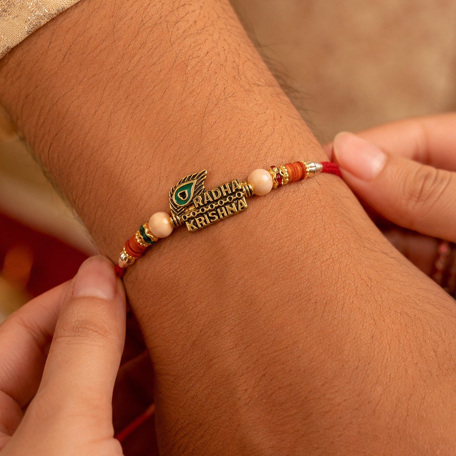 Radha Krishna Peacock Feather Stone Studded Gold Tone Rakhi for Brother