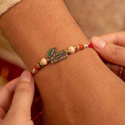 Radha Krishna Peacock Feather Stone Studded Gold Tone Rakhi for Brother