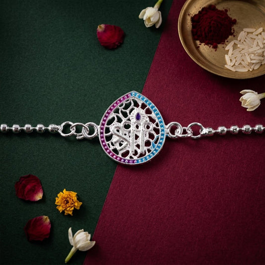 Colorful enamel Shree symbol teardrop charm on a beautiful rakhi bracelet