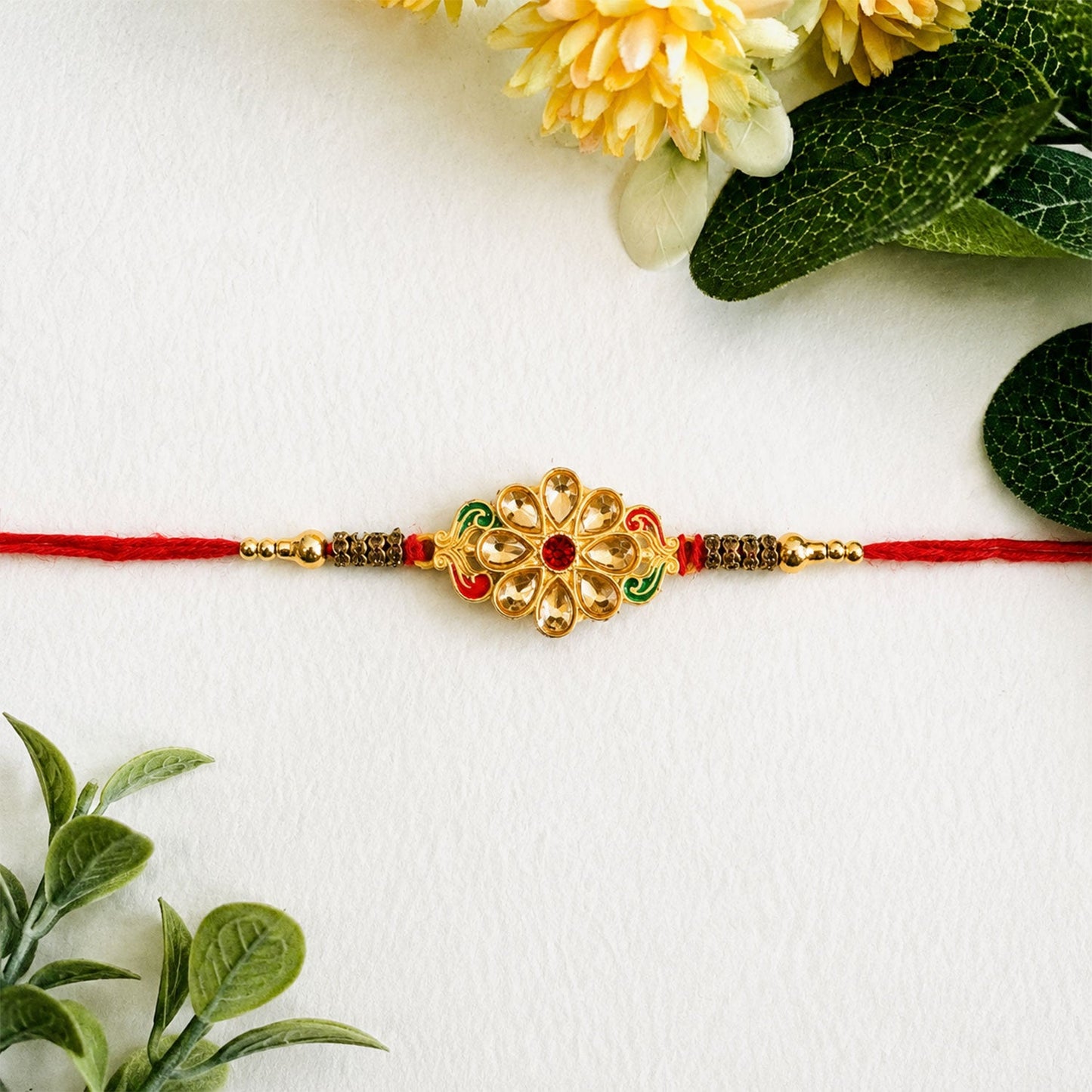 Side view of the traditional Kundan Stone Rakhi with pearl embellishments.