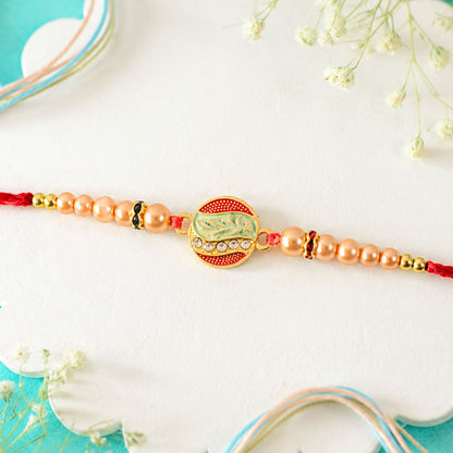 A detailed view of the Rakhi's thread and the connection to the main round motif, showcasing the craftsmanship.
