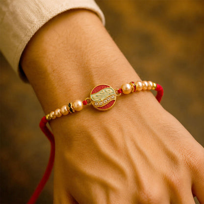 The round motif designer Rakhi displayed on a textured background, emphasizing its festive appeal.