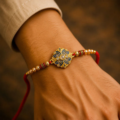 View of the red and yellow thread of the floral meenakari rakhi.