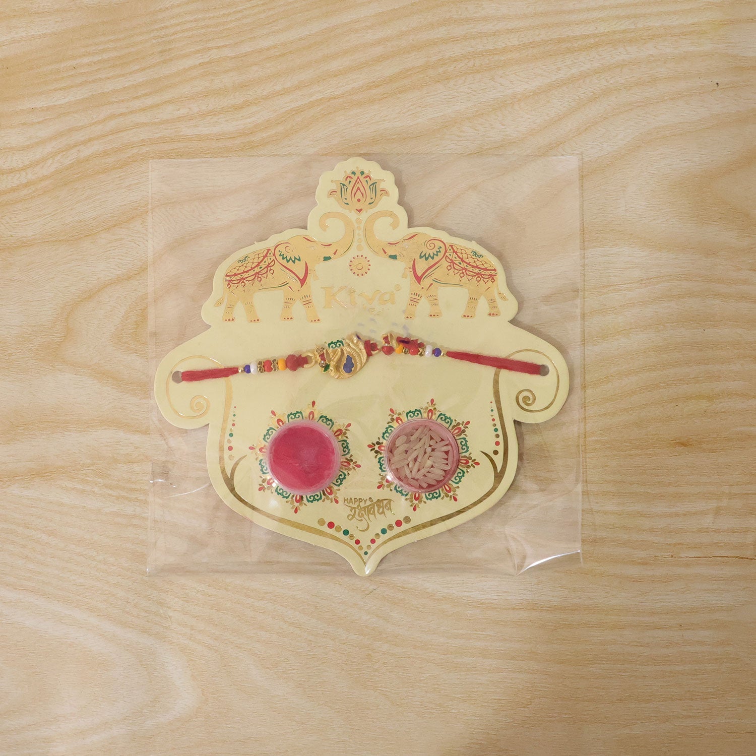 Detailed shot of the bead work and peacock charm on the Rakhi thread for brothers.