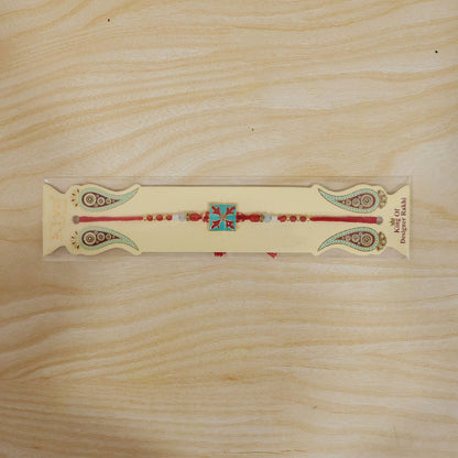 Overhead view of the Square Design Charm Kids Rakhi, showcasing its full design.